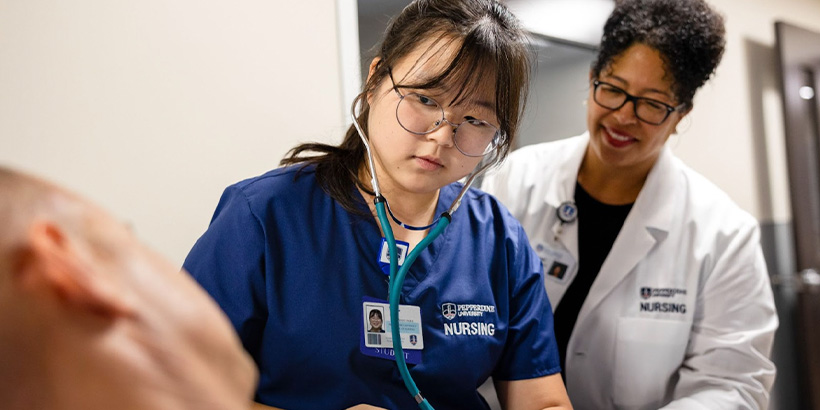 Dean Coaston working with a nursing student