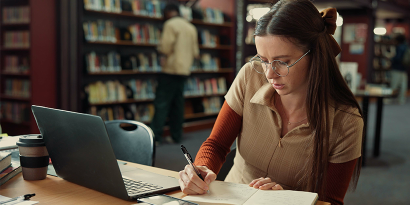 girl writing an SLP personal statement