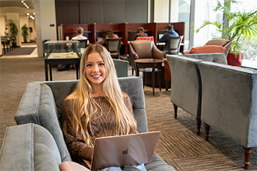 female student smiling with laptop