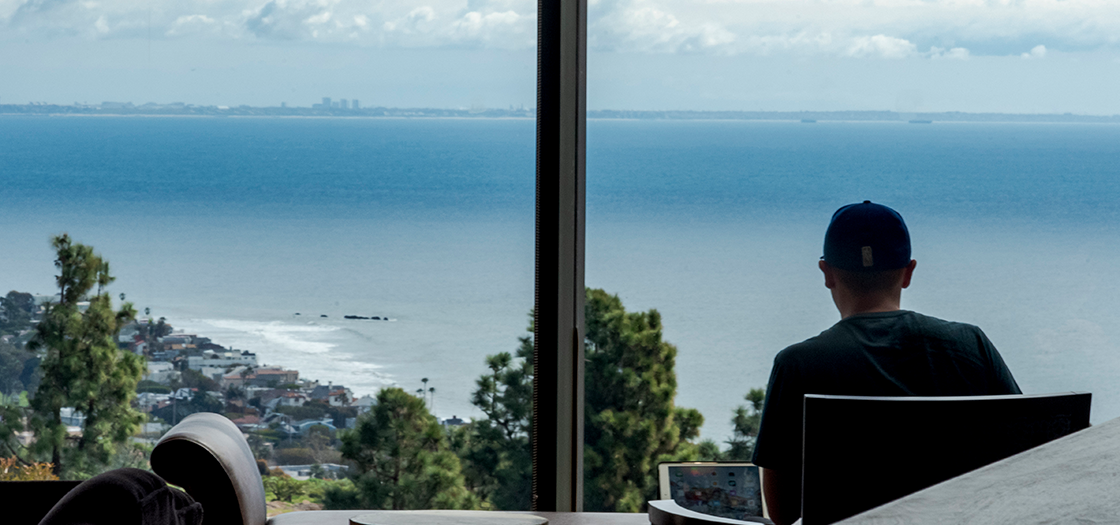 Pepperdine student working in Payson Library facing the ocean