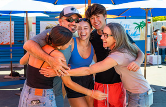 studnets and parents in group hug